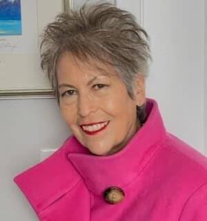 Headshot of Theresa smiling and wearing pink sweater