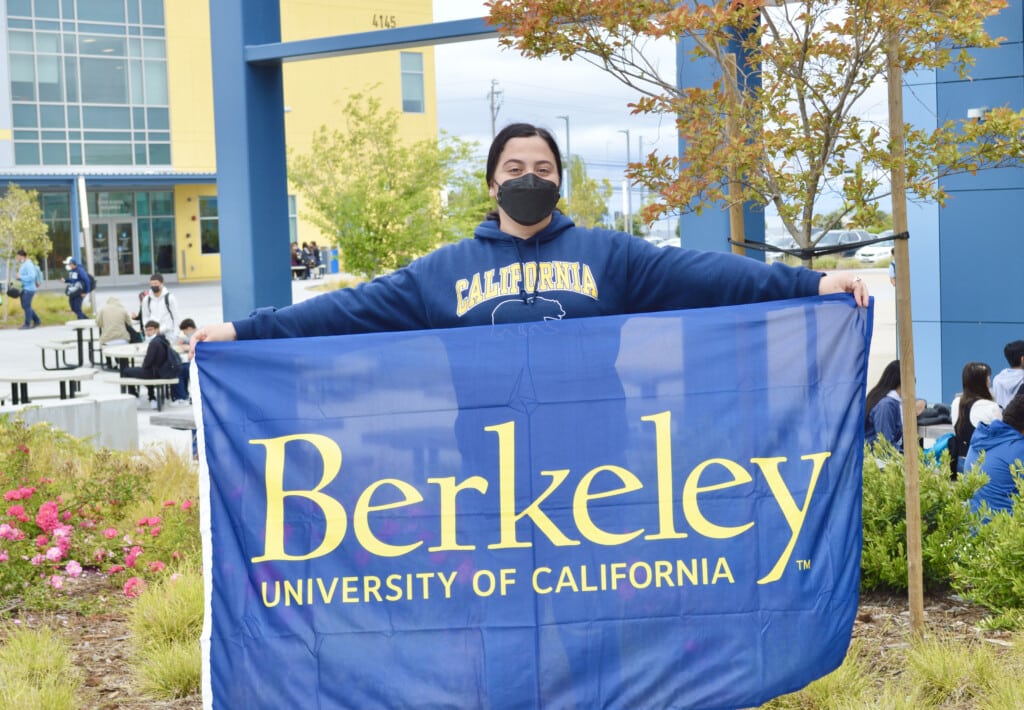 Making Waves Academy student holding Cal Berkeley flag