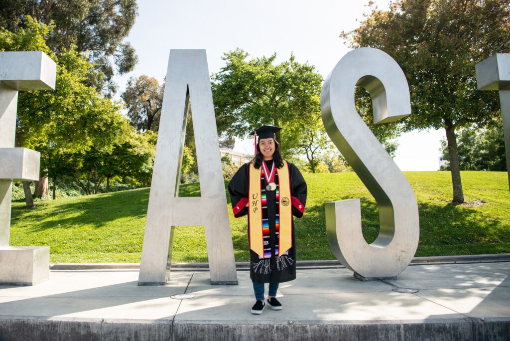 Jennifer in university honors program stole at Cal State East Bay sign