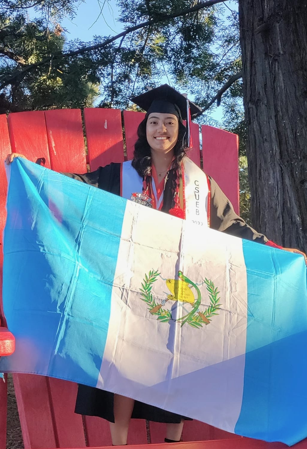 Jennifer with Guatemala flag at graduation