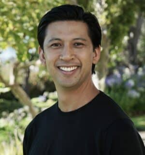 Jon Siapno smiling for his headshot with a black T-Shirt