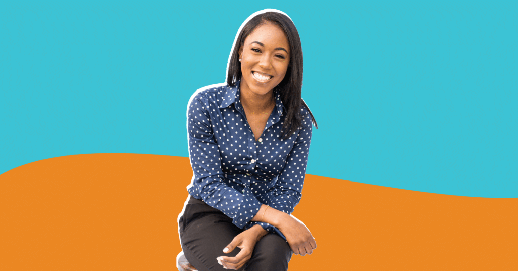 Photo of Adrianna Boles in a blue polka dot shirt with an orange and blue background