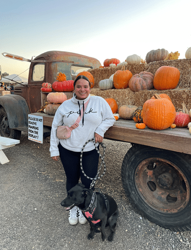Brenda at a pumpkin patch with her dog