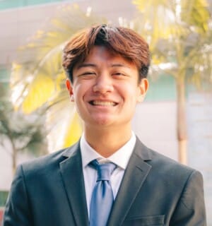 Kieran Vu smiling wearing tie and suit jacket