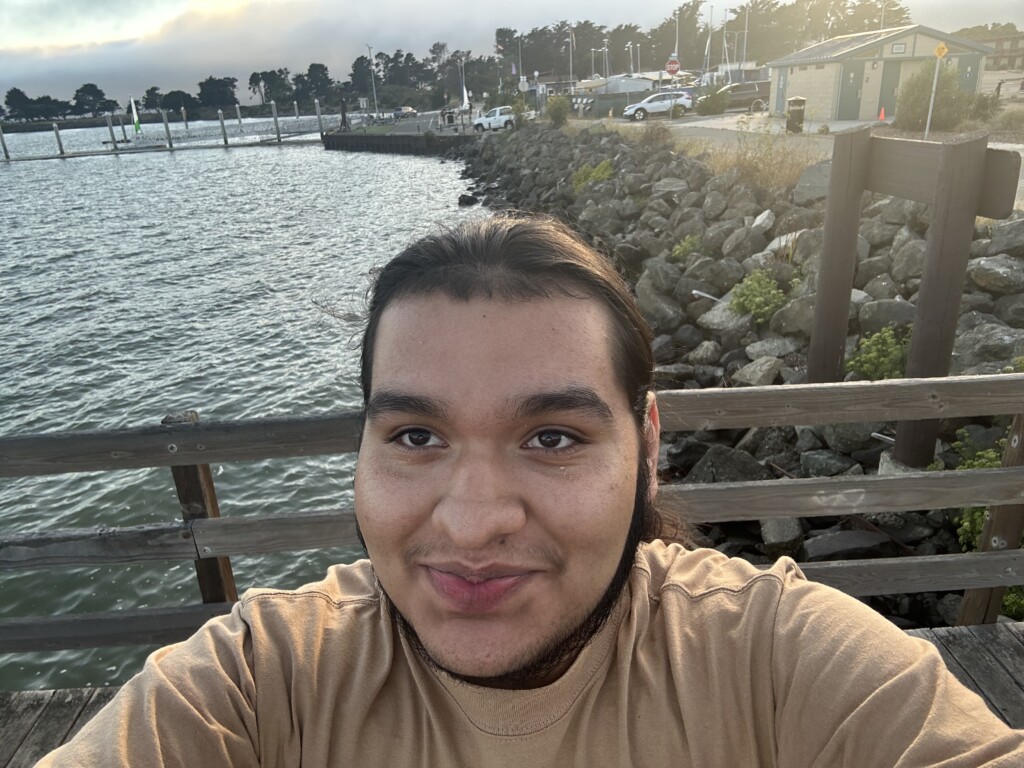 Salvador taking a selfie in front of a bay of water