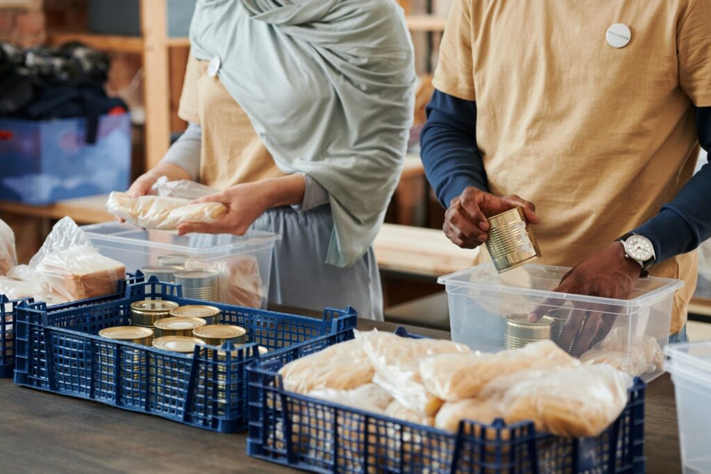 Photo of two people bagging food items at a pantry