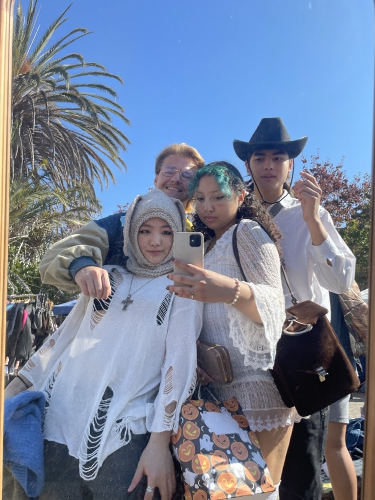Ale taking selfie with three friends on college campus