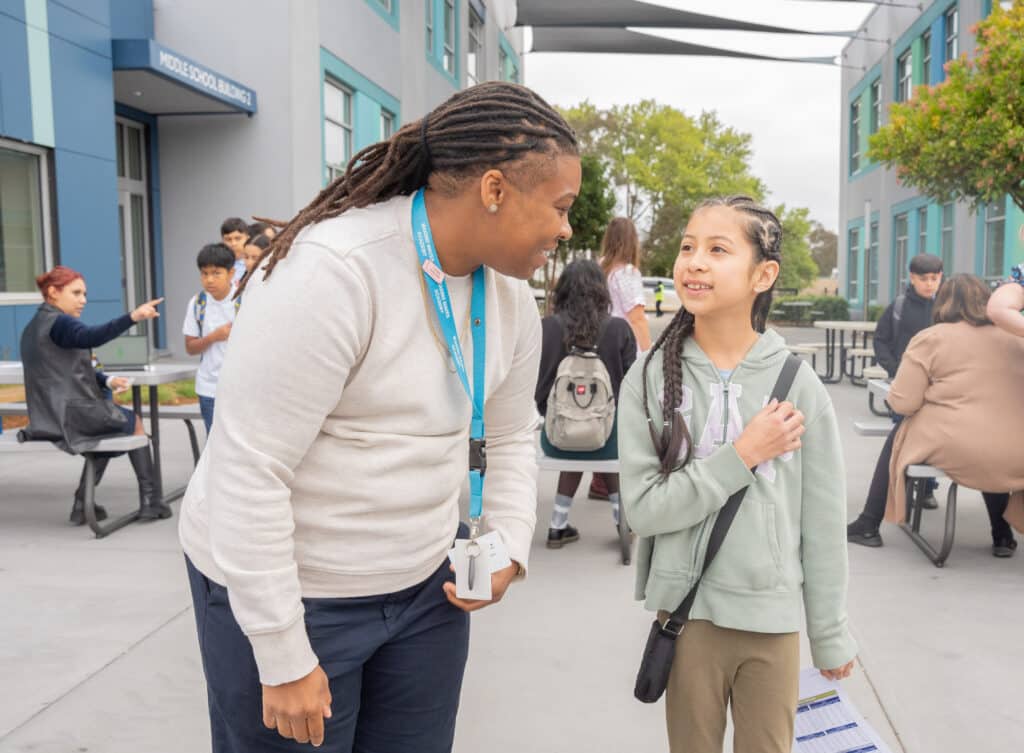 Teacher and student talking outside