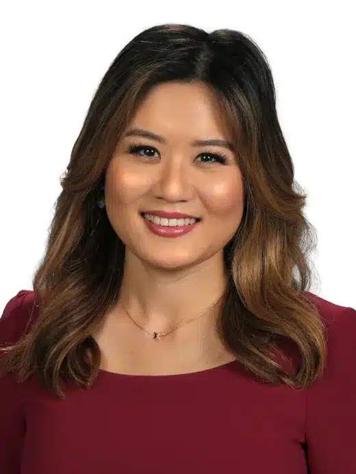 Stephanie Lin smiling wearing red sweater