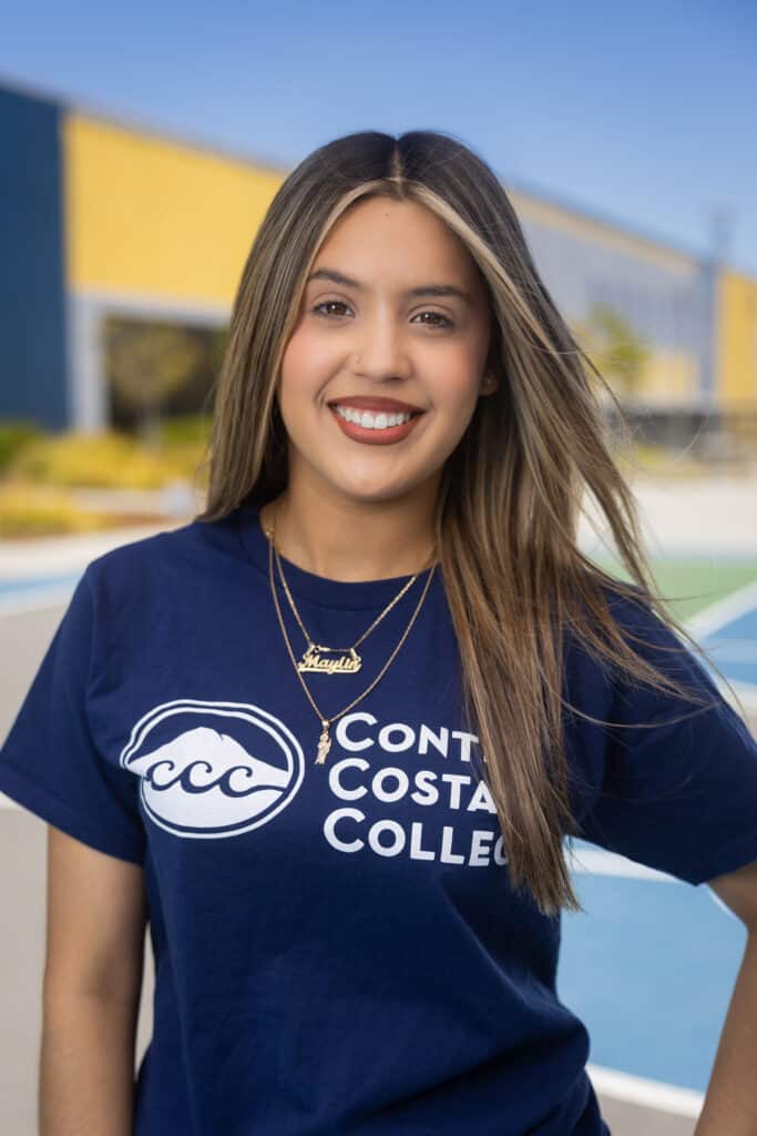 Maylin smiling in Contra Costa County shirt