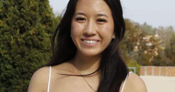 Photo of Anna Vo smiling with greenery in background