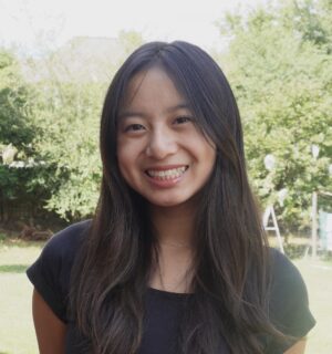 Photo of candace smiling with trees in the background