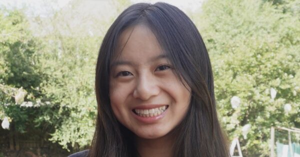 Photo of candace smiling with trees in the background